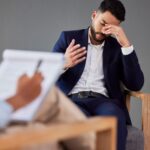 sad man consulting therapist in therapy or counsel 39hmnfy