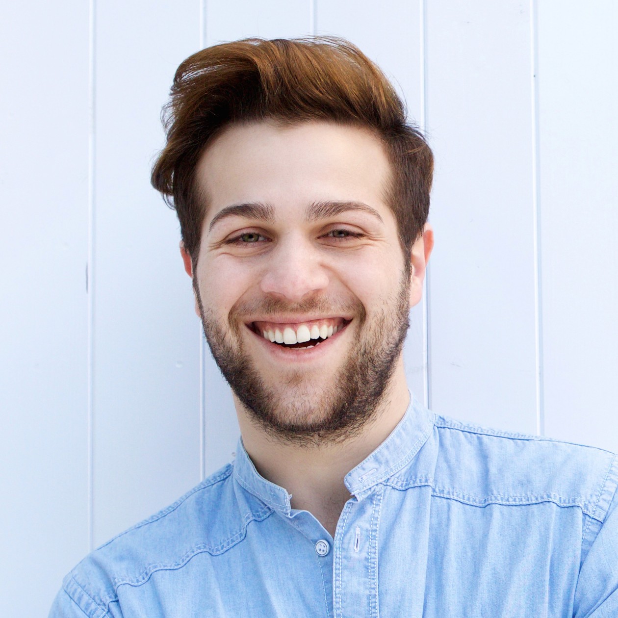 attractive young man smiling with arms crossed pf8hn7l 1 1.jpg