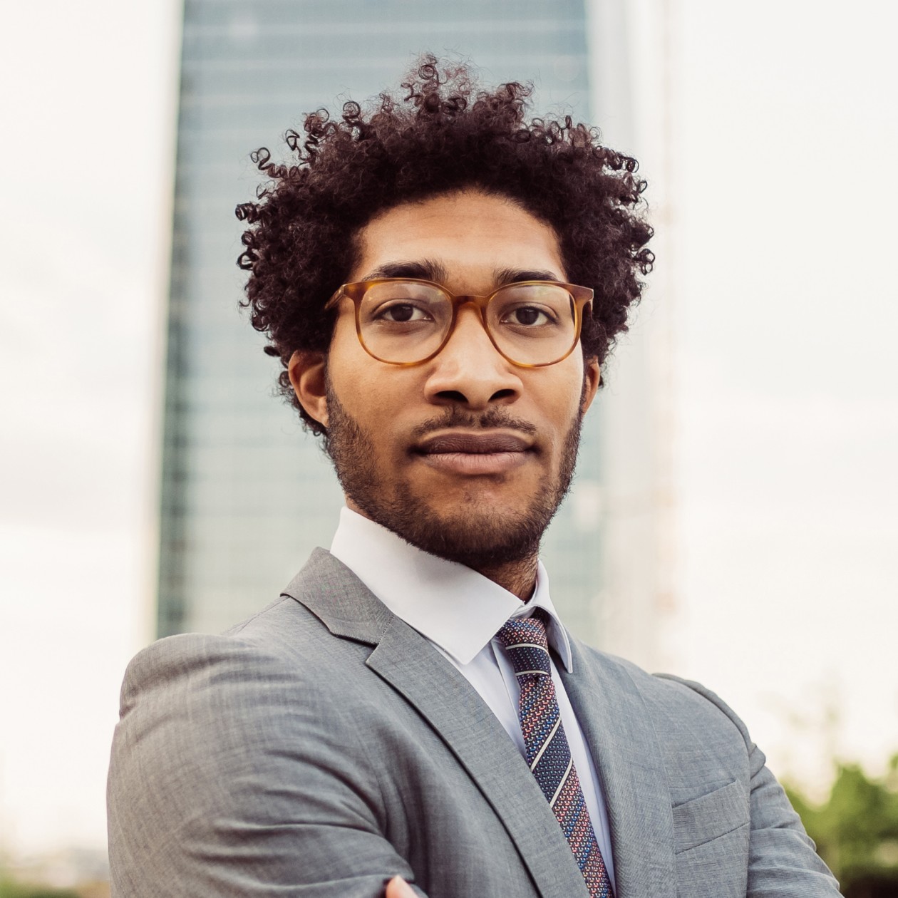 portrait of businessman wearing glasses and grey s bkamntd 1 1.jpg